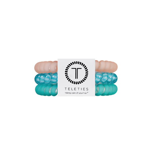 Turquoise hair ties with a white card displaying 'Teleties' brand on a white background