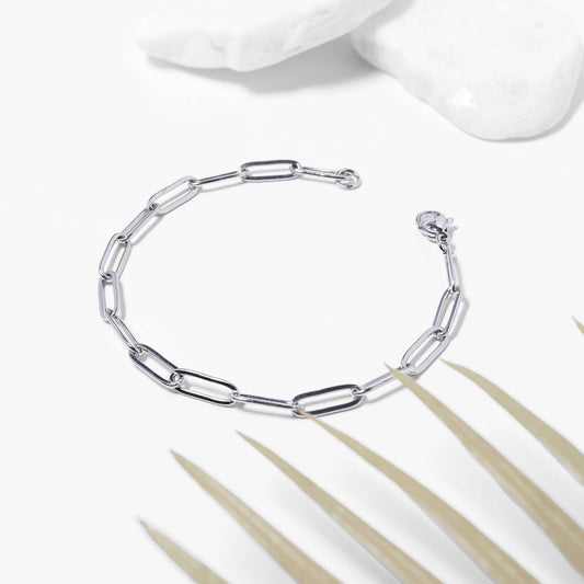 Silver bracelet on a white background with a minimalistic design