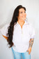 Woman wearing a striped shirt and jeans against a plain background