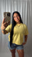Butter yellow short sleeve knit sweater with exposed seam and distressed denim shorts