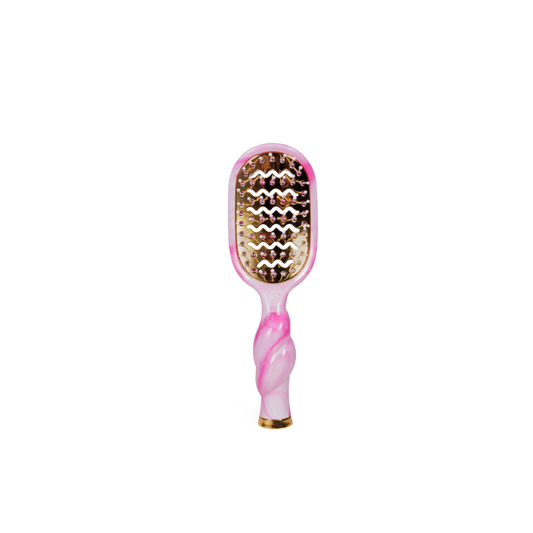 Pink and gold hairbrush on a white background