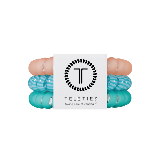 Turquoise hair ties with a visible brand logo on a white background