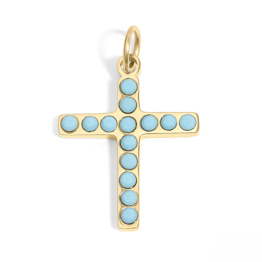 Gold cross pendant with light blue stones on a white background